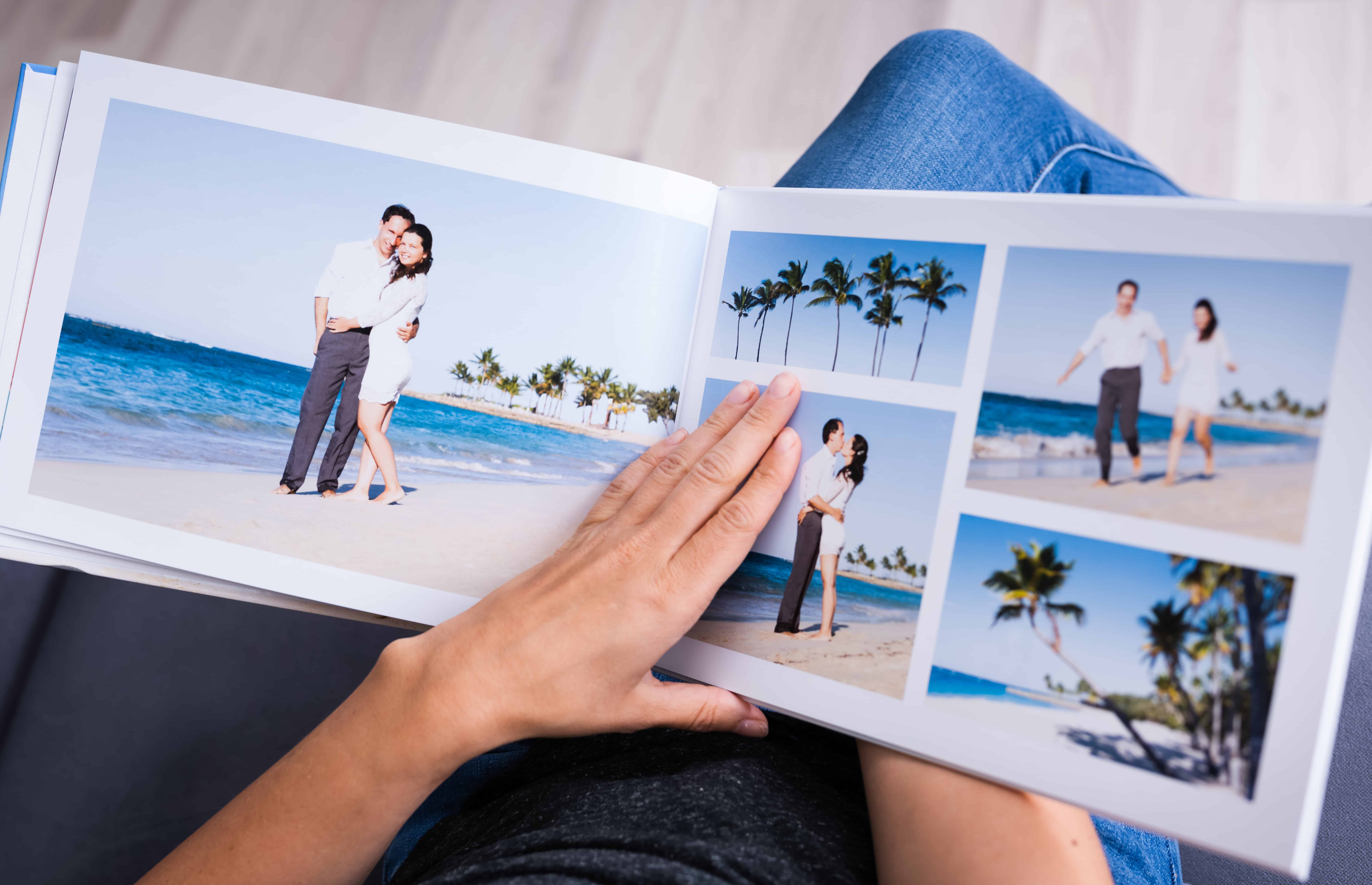 Open photo book to pages wth pics of couple on beach